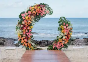 “Stunning tropical wedding arch adorned with vibrant exotic flowers and lush greenery, creating a romantic and elegant backdrop for a tropical-themed ceremony