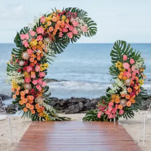 “Stunning tropical wedding arch adorned with vibrant exotic flowers and lush greenery, creating a romantic and elegant backdrop for a tropical-themed ceremony
