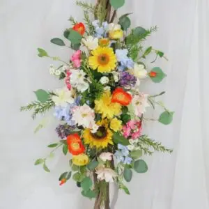 Wildflower wedding tie-back featuring sunflowers, daisies, dahlias, and ranunculus, designed for a boho spring wedding backdrop, arbour, or gazebo decoration