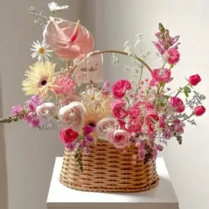 Charming floral basket arrangement featuring soft pink blooms in a sweet and delicate design, perfect for expressing love, gratitude, or celebration