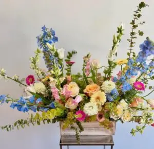 omantic floral arrangement featuring garden roses, ranunculus, lisianthus, stock, and seasonal greenery, inspired by Plato’s quote ‘Everyone becomes a poet,’ ideal for literary events, weddings, or thoughtful gifts