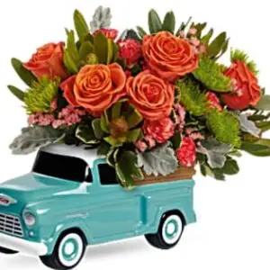 Cheerful vintage-style blue Chevy truck keepsake filled with bright orange flowers, designed as an uplifting floral gift to send encouragement